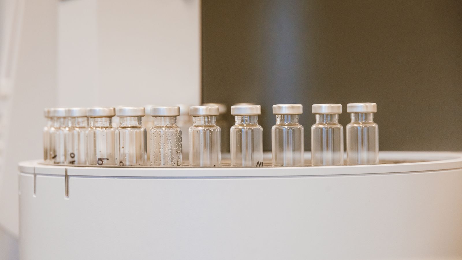 Close-up of empty glass vials arranged in a laboratory environment.